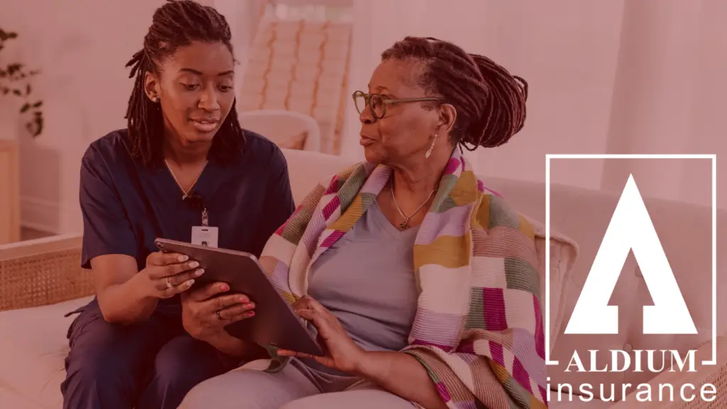 Caregiver shows a tablet to an elderly woman sitting on a couch, with ALDIUM Insurance branding on the right.