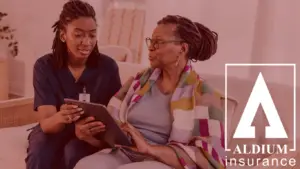 Domiciliary Care Insurance - ALDIUM Insurance - ALDIUM Insurance Caregiver shows a tablet to an elderly woman sitting on a couch, with ALDIUM Insurance branding on the right.